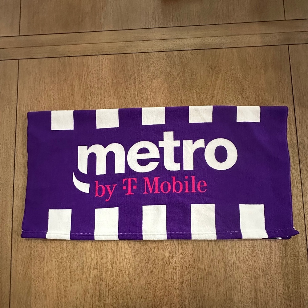 T-Mobile Tuesdays Towel in purple, pink, and white 100% polyester